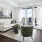 a living room with a white couch and a green chair