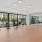 a large room with glass walls and a wood floor