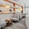 a room with a wood floor and a white wall with a bookcase