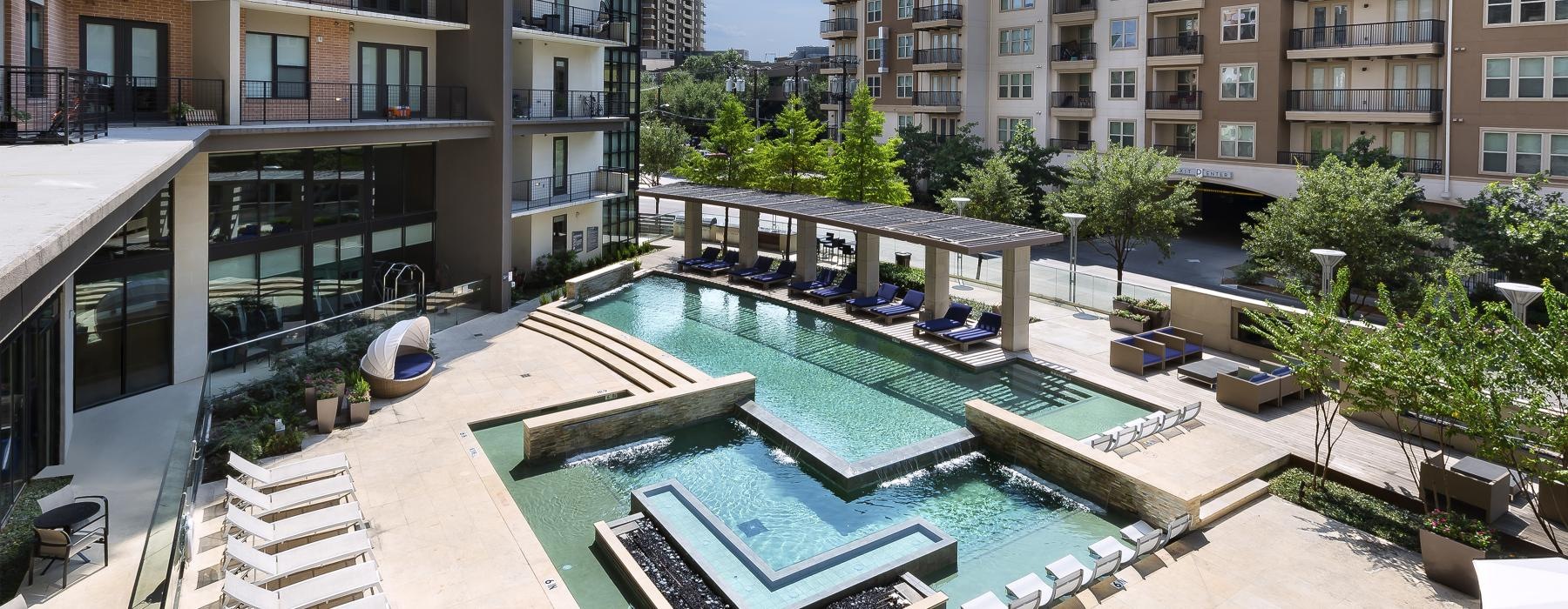 a swimming pool in a courtyard between buildings