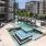 a swimming pool in a courtyard between buildings